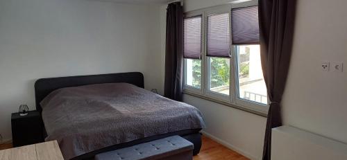 a bedroom with a bed and a large window at Schnick Schnack in Kröv