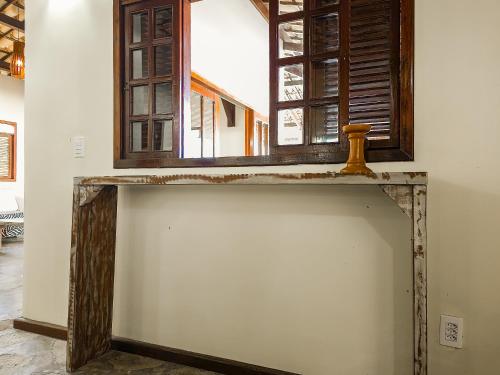 a window with a wooden frame on a wall at Sunset Beach Villas in Taíba