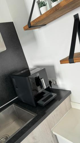 a coffee machine sitting on a kitchen counter at Woonboot 4 Harderwijk in Harderwijk