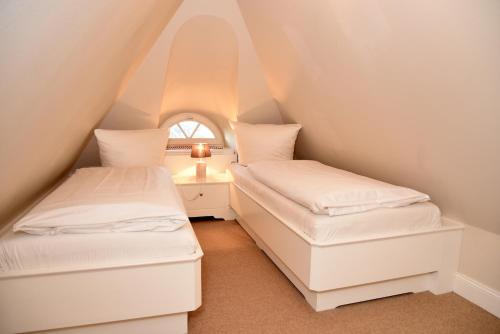 En eller flere senge i et værelse på Residenz Wenningstedt