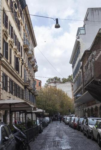a street with cars parked on the side of a city at Casa nicola- apt in the heart of Rome in Rome