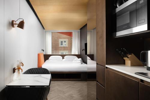a hotel room with a bed and a kitchen at StowAway Waterloo in London