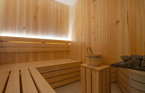 a wooden sauna with a wooden bench in a room at Hotel Agape in Zlatibor