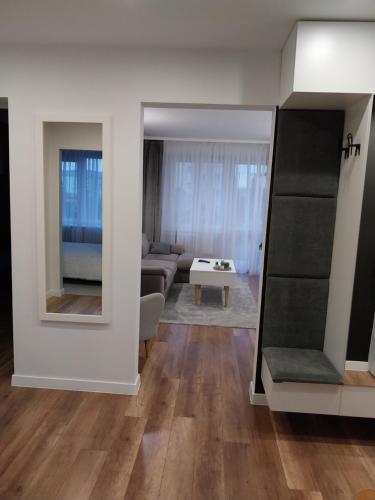 a living room with a couch and a table at Apartament na Sadowej in Sanok