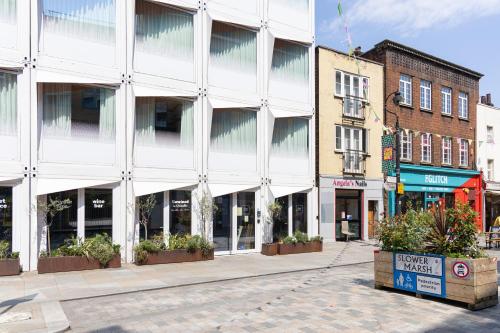 an empty city street with a large white building at Stow Away Waterloo in London