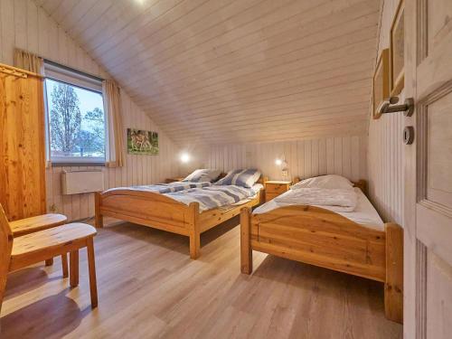 a room with two beds and a window at Wildgans Classic 249 in Mirow