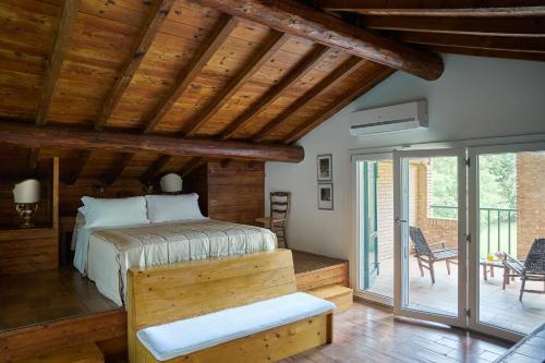 a bedroom with a bed and sliding glass doors at Casa Mancini Monticiano - Holiday Villa in Monticiano
