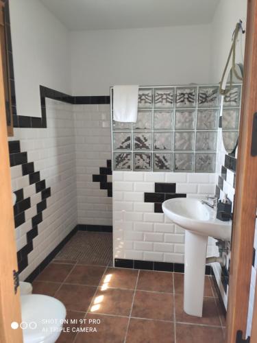 a bathroom with a sink and a toilet at Vista al faro in Cádiz