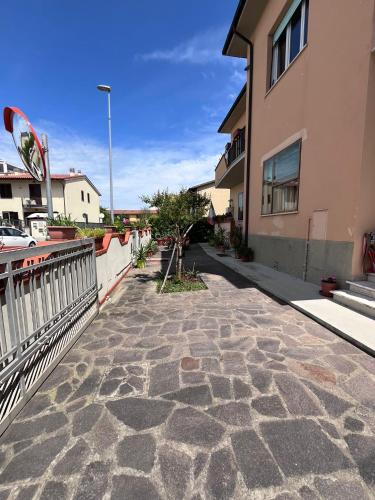 a stone walkway in front of a building at ViaVai Pisa Airport in Pisa