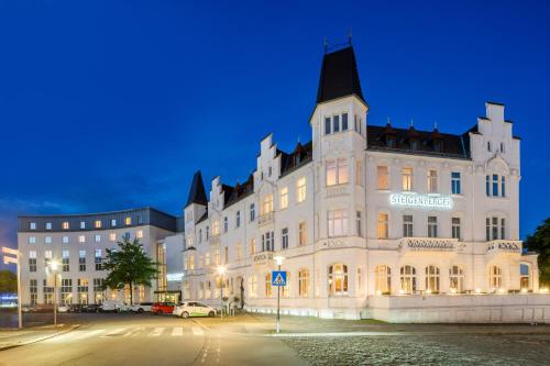 ein großes weißes Gebäude mit schwarzem Dach in der Unterkunft Steigenberger Hotel Bielefelder Hof in Bielefeld