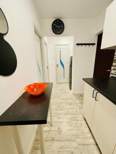 an orange bowl on a table in a kitchen at Apartament Olimp in Olimp