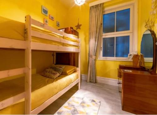 a bedroom with two bunk beds and a desk at Ocean view in Swanage