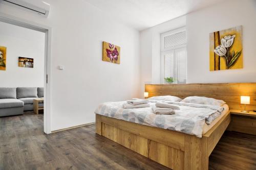 a bedroom with a large wooden bed in a room at Apartmány Děčín in Děčín