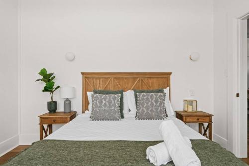 a bedroom with a large white bed with pillows at 1930's Character Cottage - Beautifully Restored in McLaren Vale