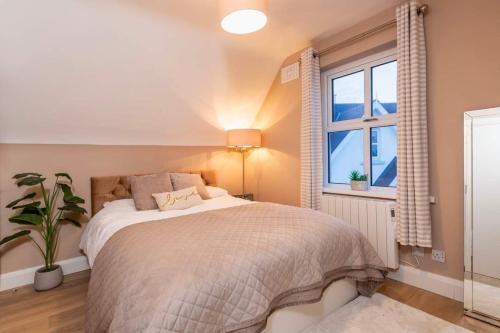 a bedroom with a bed and a window at Sunny Cottage in Wexford