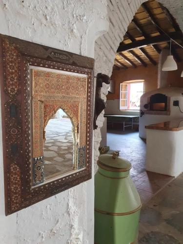 a mirror on the side of a wall in a room at Hotel Rural El Vaqueril in Navas del Madroño