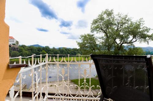 a balcony with a view of a body of water at Apartmány Děčín in Děčín