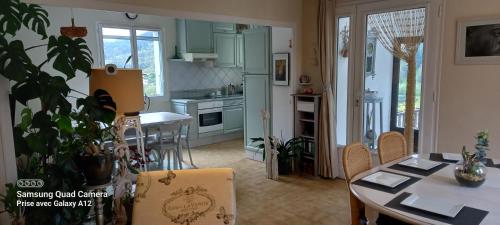 a kitchen and dining room with a table and chairs at MALPAS125 maison 6 chambres 10personnes in Accons
