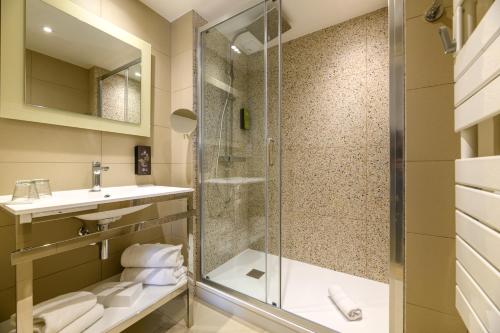 a bathroom with a shower and a sink at Best Western Plus Ajaccio Amirauté in Ajaccio