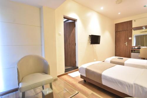 The Aarya A Smart Business Hotelにあるベッド