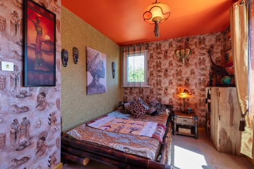 a bedroom with a bed in a room with wallpaper at Princess Palace in Gdańsk