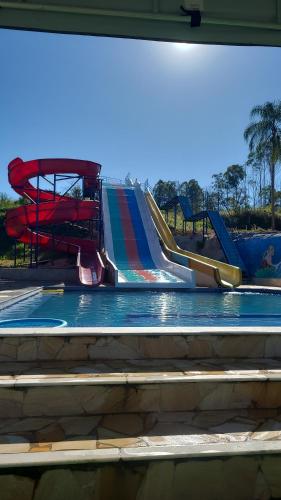 a slide at a water park with a playground at Pousada Kart Clube in São João del Rei
