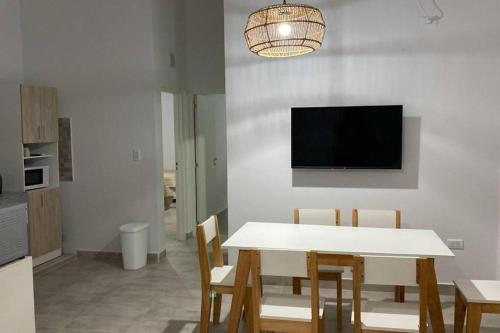 a dining room with a white table and chairs at Cerros de Cafayate, Casa Nº2 in Cafayate