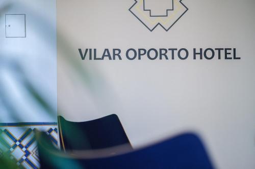 a close up of a hat in front of a var opera hotel at Vilar Oporto Hotel in Porto