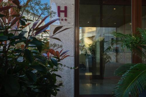 a door of a building with plants in front of it at Vilar Oporto Hotel in Porto