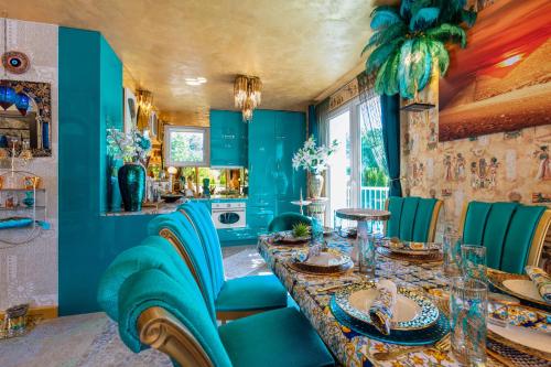 a blue kitchen with a table and blue chairs at Princess Palace in Gdańsk