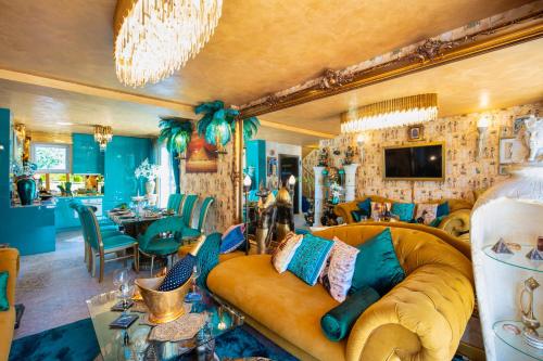 a living room with a couch and a dining room at Princess Palace in Gdańsk