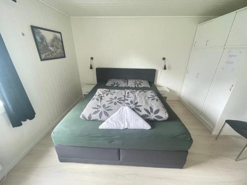 a small bedroom with a bed in a room at Åndalsnes Apartments - Luxury Stay in Åndalsnes