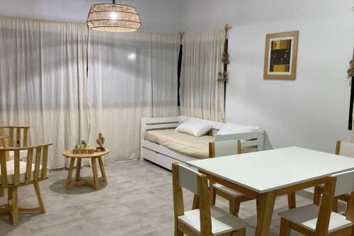 a bedroom with a bed and a table and chairs at Cerros de Cafayate, Casa Nº1 in Cafayate