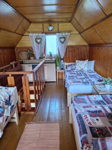 a room with two beds and a kitchen in a house at Chata u tří borovic in Chvalatice