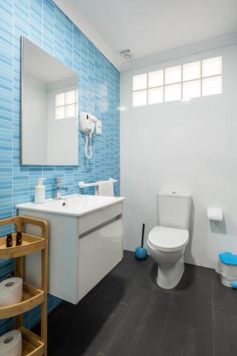 a bathroom with a white sink and a toilet at West Side Guesthouse in Peniche