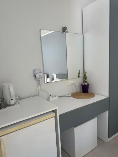 a bathroom with a sink and a mirror at Potami Seashell in Himare