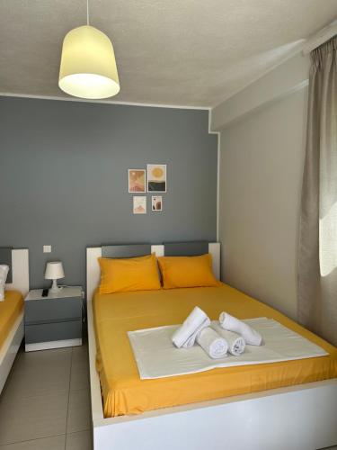 a bedroom with a bed with towels on it at Potami Seashell in Himare