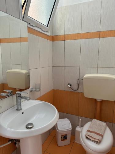 a bathroom with a sink and a toilet at Potami Seashell in Himare