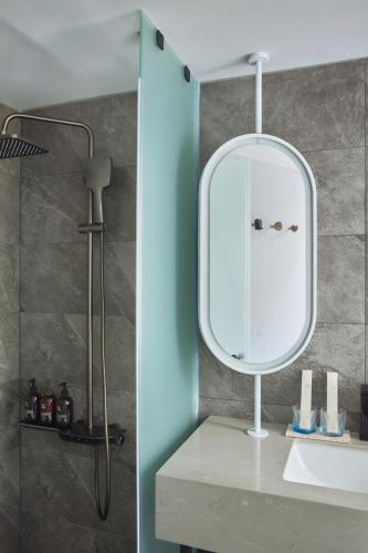 a bathroom with a sink and a mirror at The Blue by Just Inn in Taipei
