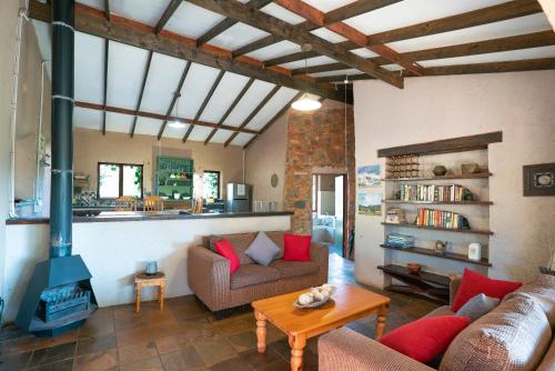 a living room with a couch and a stove at Kokopelli farm in Magaliesburg