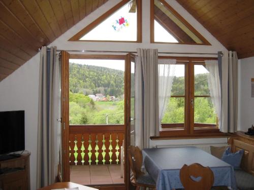 a room with a table and a large window at Appartement in Wittenschwand mit Garten und Grill und Panoramablick in Wittenschwand