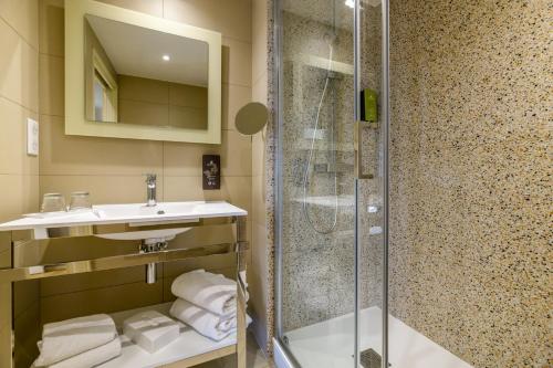 a bathroom with a shower and a sink at Best Western Plus Ajaccio Amirauté in Ajaccio