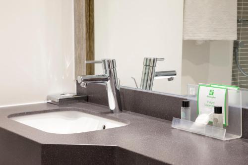 a bathroom counter with a sink and a mirror at Holiday Inn Chester South by IHG in Chester