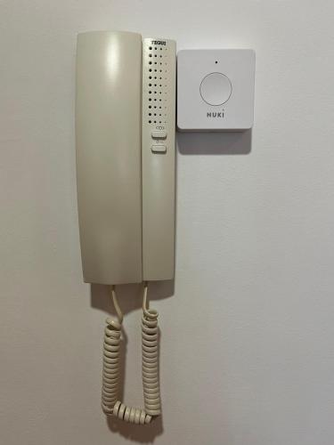 a phone is hanging on a wall at Ánade Real Guest House in Daimiel