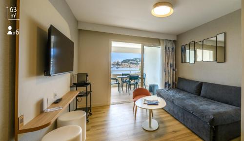 a living room with a couch and a table at Best Western Plus Ajaccio Amirauté in Ajaccio
