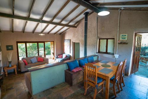 a living room with a table and a couch at Kokopelli farm in Magaliesburg