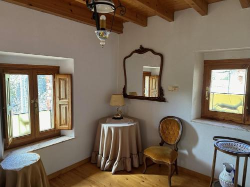 a room with a table and a mirror and a chair at Casa rural C de Caballo, Valdorria Brother Law SL in Valdorria