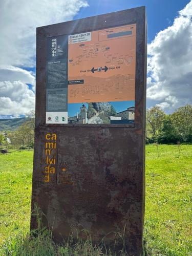 a sign in the grass in a field at Casa rural C de Caballo, Valdorria Brother Law SL in Valdorria