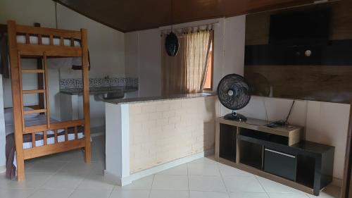 a kitchen with a counter and a ladder in a room at Pousada Kart Clube in São João del Rei
