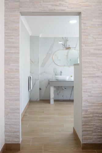 a bathroom with a sink and a mirror at West Side Guesthouse in Peniche